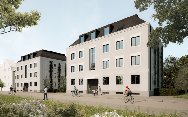 Moderne Wohngebäude an einer Straße, umgeben von Radfahrern und Spaziergängern.